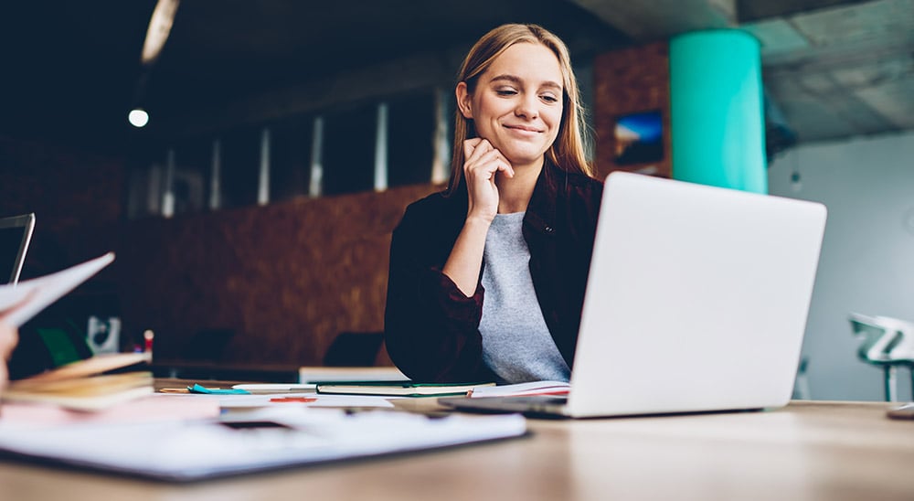 0417 Instruct  Manage Documents  Female professional smiling at laptop