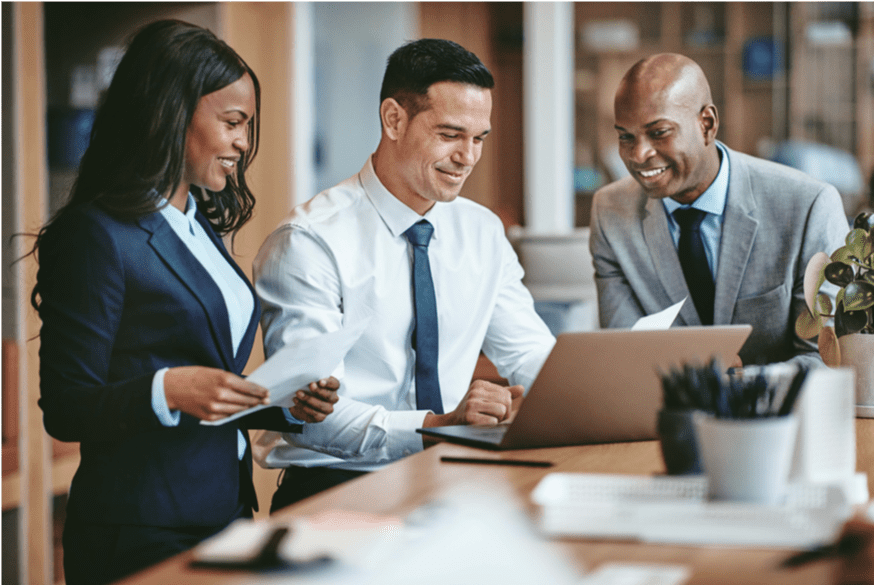 Three business workers looking at computer