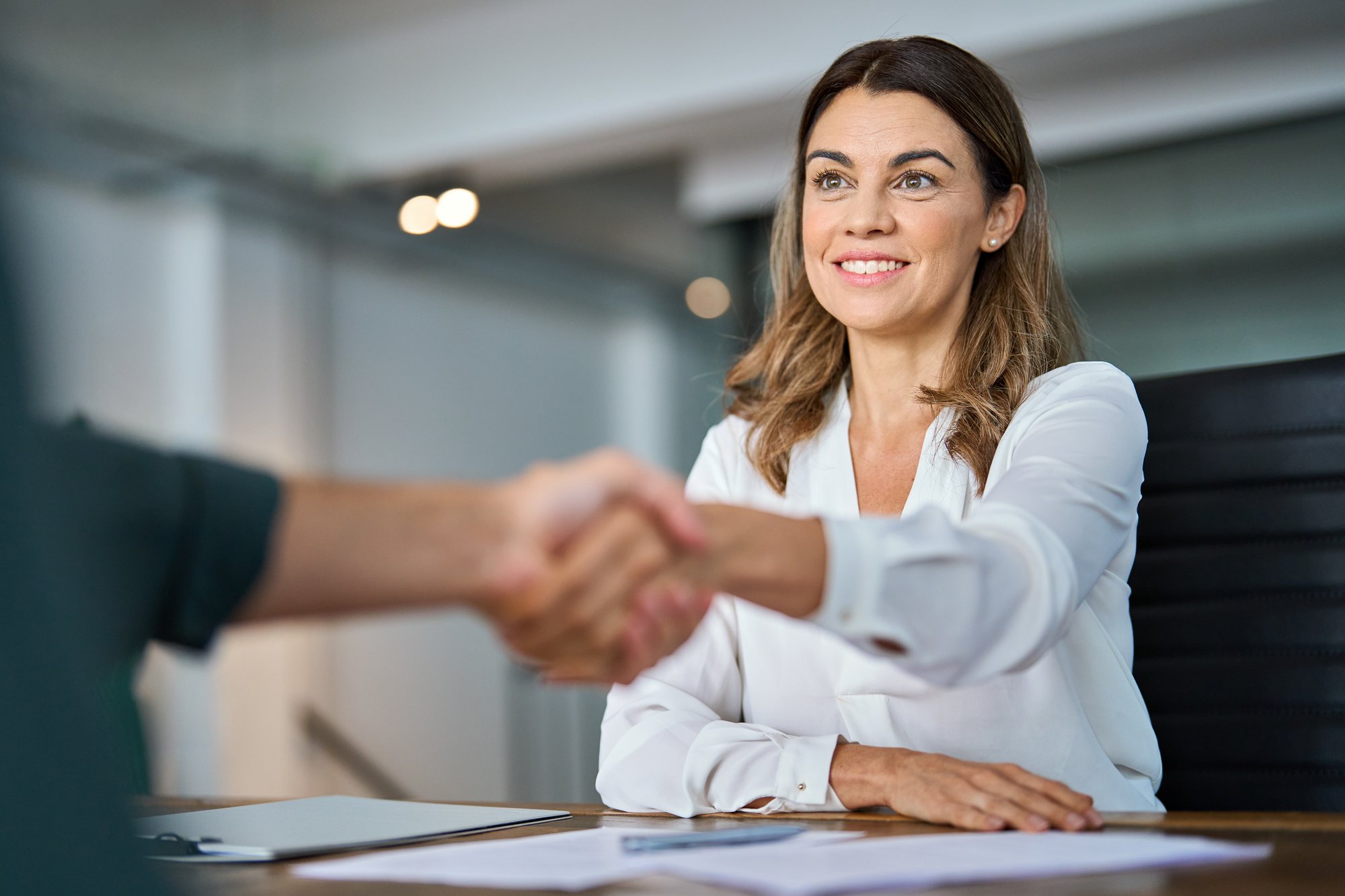 Broker shaking hands with client