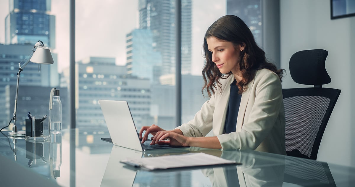 Woman in office working on laptop