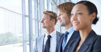 Three business professionals looking forward. 