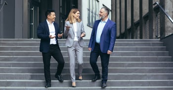 Business professionals meeting while on steps. 