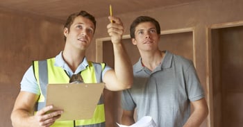 Home inspector and home owner reviewing issue