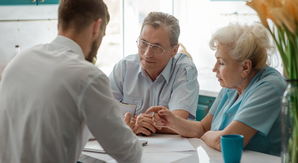 Credit Counselor meeting with an older couple