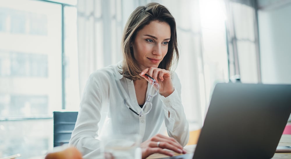 A female lender accessing refinance documents on her laptop