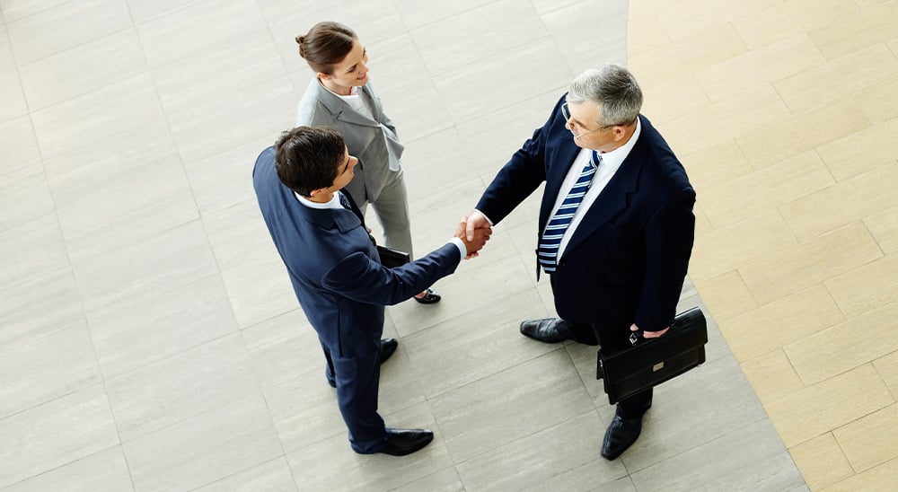 Business people shaking hands in an open office space