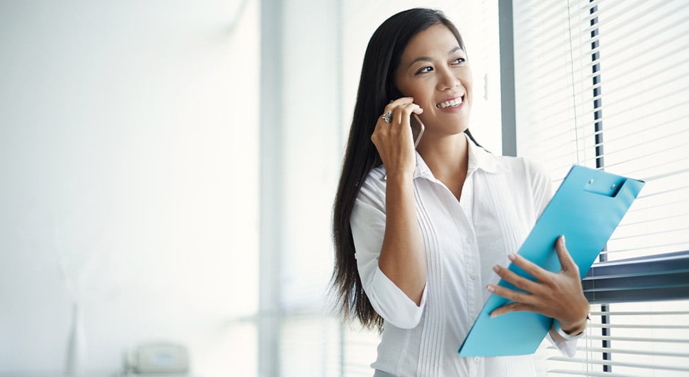 Woman on phone with clipboard