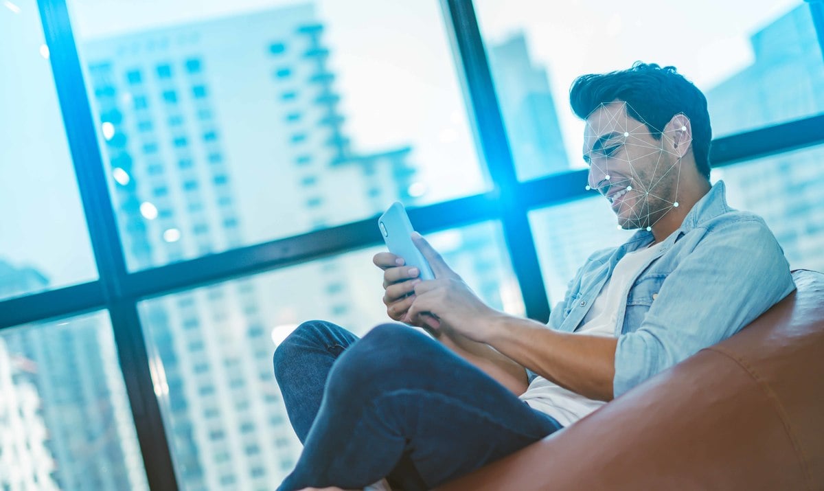 Man sitting on chair using mobile phone