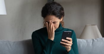 Woman using phone worried