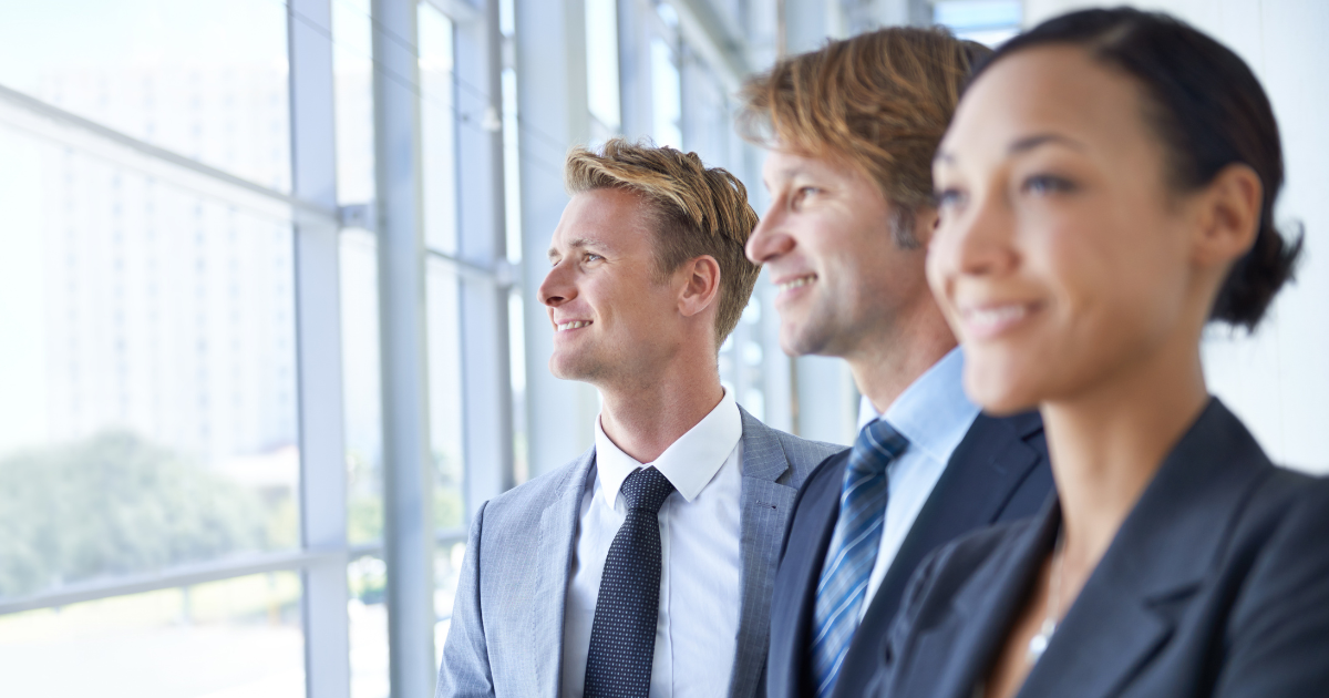 Three business professionals looking forward. 